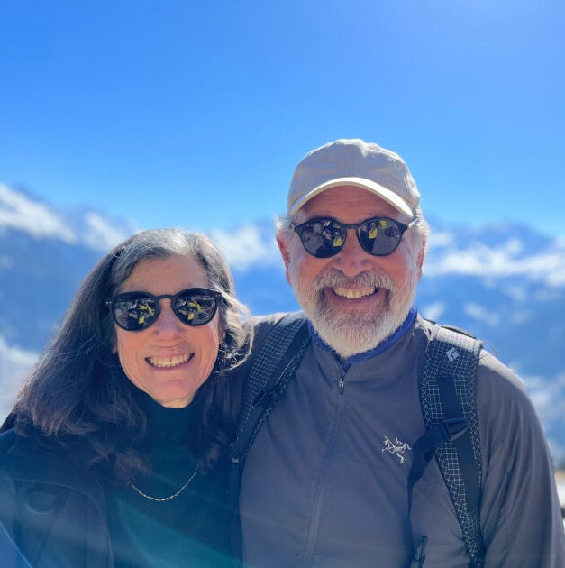 a picture of a man and a woman with a snowy mountain background