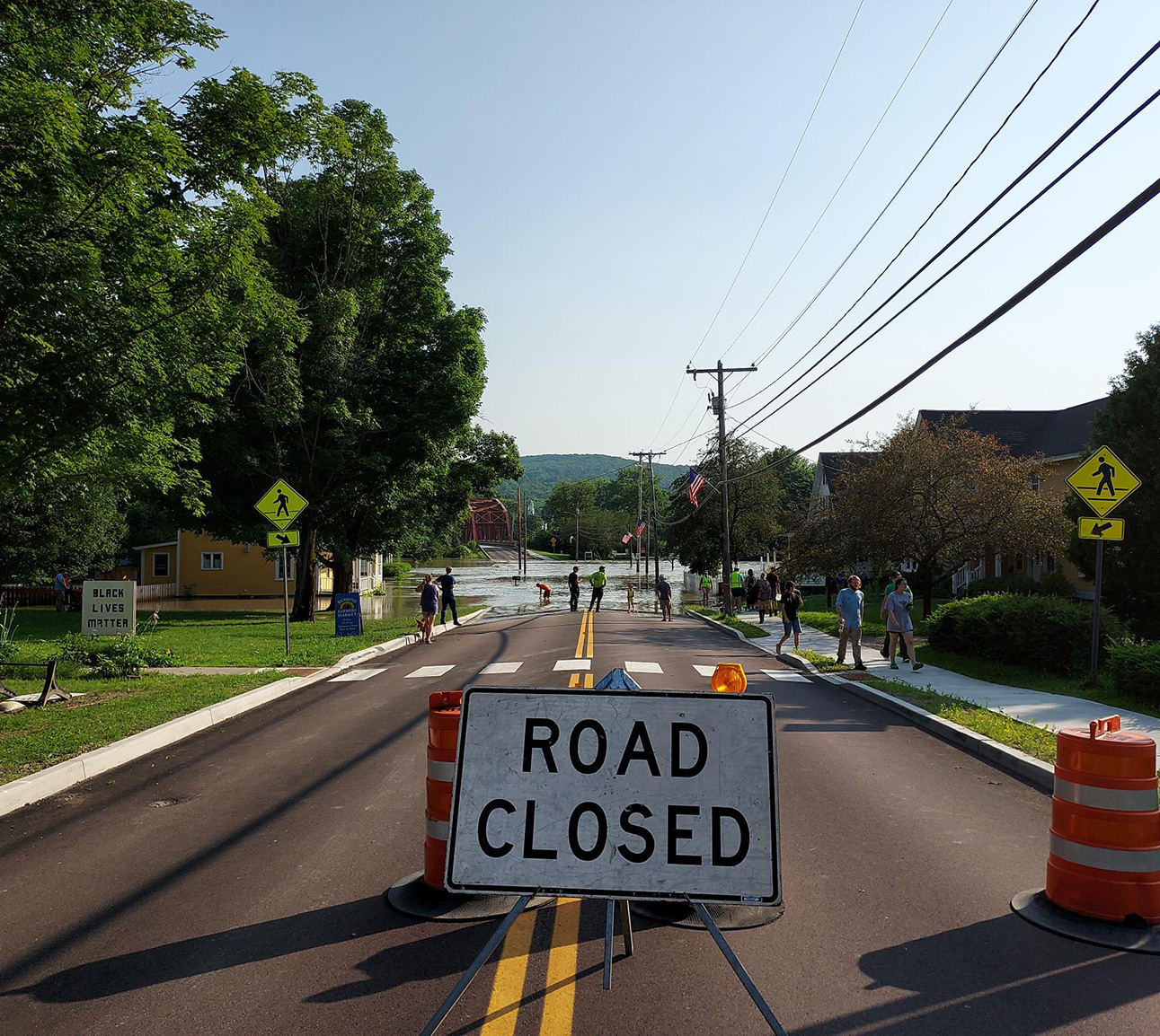 A road closed sign blocks a flooded road in Richmond Vermont.