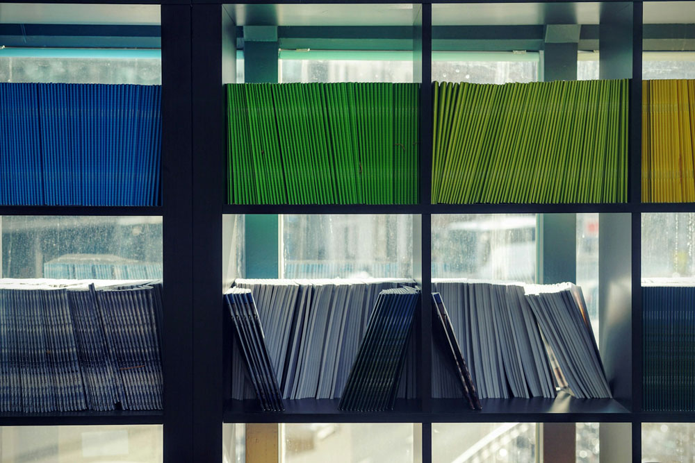 shelves of documents sorted by color