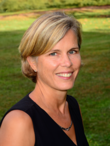 a woman with blond hair in a black shirt