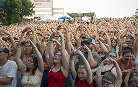 Crowd of people holding up their hands in the shape of a heart at Do Good Fest