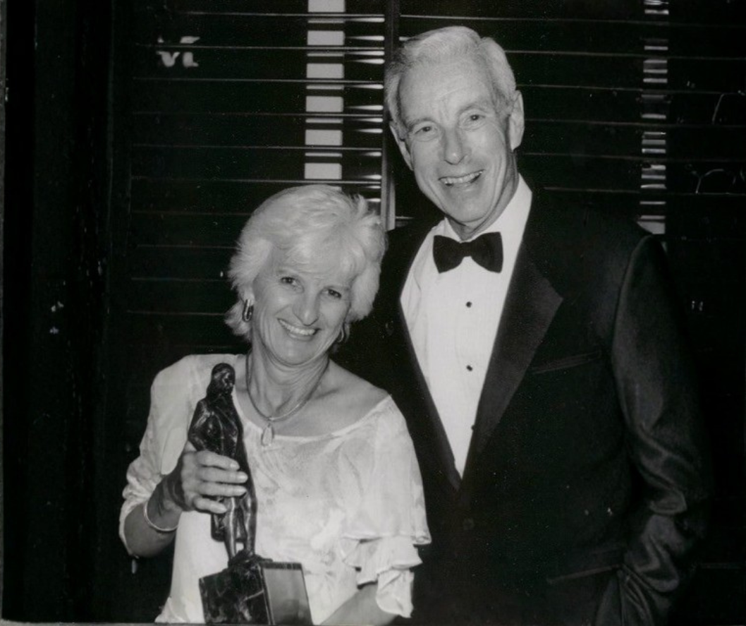 Lois and Mac McClure holding an award