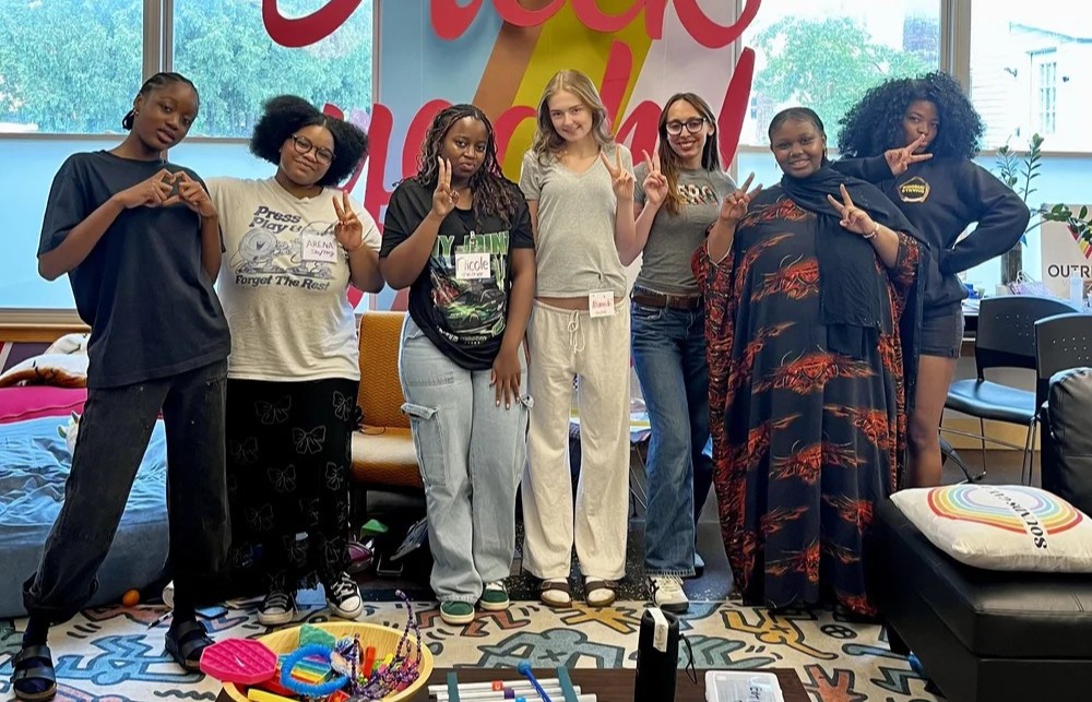 A group of girls standing together smiling at Education Justice Coalition of Vermont