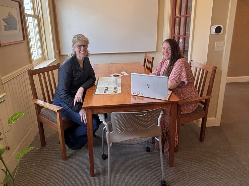 Amy and Anna sitting across from each other in an office