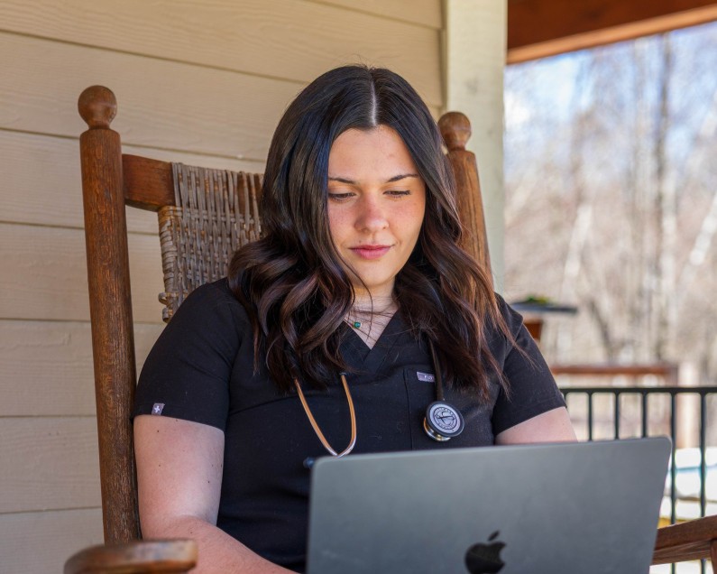 Kallie Carter, a student sits with her computer