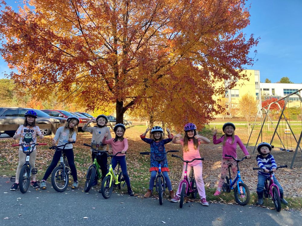 kids smiling at the camera while on bikes