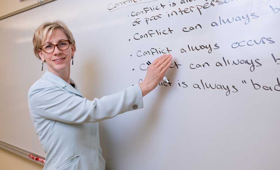 Teacher at a white board